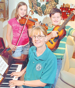 Trish and family at the piano